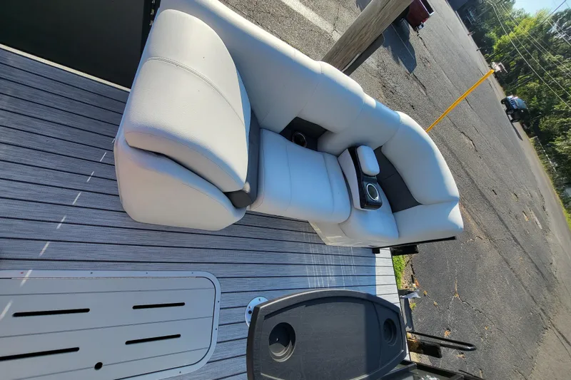 Slide: The Image of 2023 SunCatcher Fusion 322RC boat seating area with cup holders and gray flooring. - 14