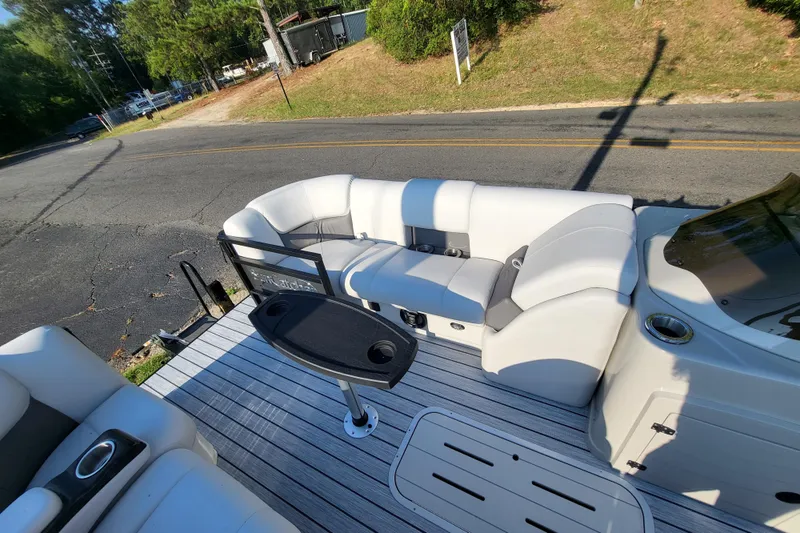 Slide: The Image of 2023 SunCatcher Fusion 322RC boat interior with white seating and table. - 5