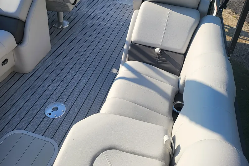 Slide: The Image of 2023 SunCatcher Fusion 322RC boat interior with comfortable seating and sleek flooring. - 6