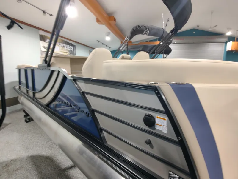 Slide: The Image of 2024 South Bay 523E 2.75 pontoon boat in showroom, side view. - 11