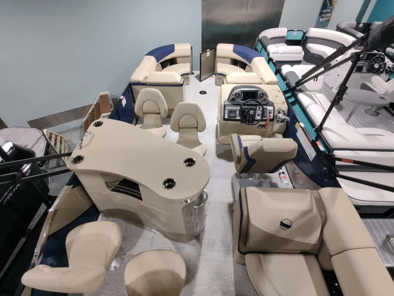 Slide: The Image of 2024 South Bay 523E 2.75 pontoon boat interior with beige seating and modern helm. - 13