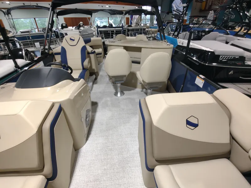 Slide: The Image of 2024 South Bay 523E 2.75 pontoon boat interior with beige and blue seating. - 15
