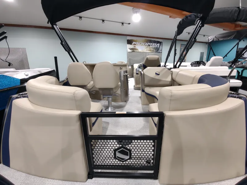 Slide: The Image of 2024 South Bay 523E 2.75 pontoon boat interior with beige seating and black canopy. - 4