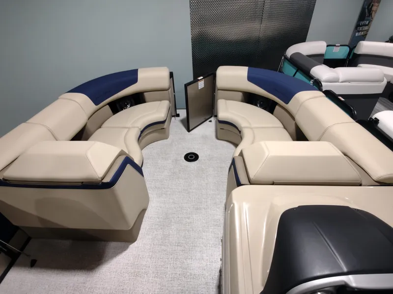 Slide: The Image of 2024 South Bay 523E 2.75 pontoon boat interior with beige and blue seating. - 6