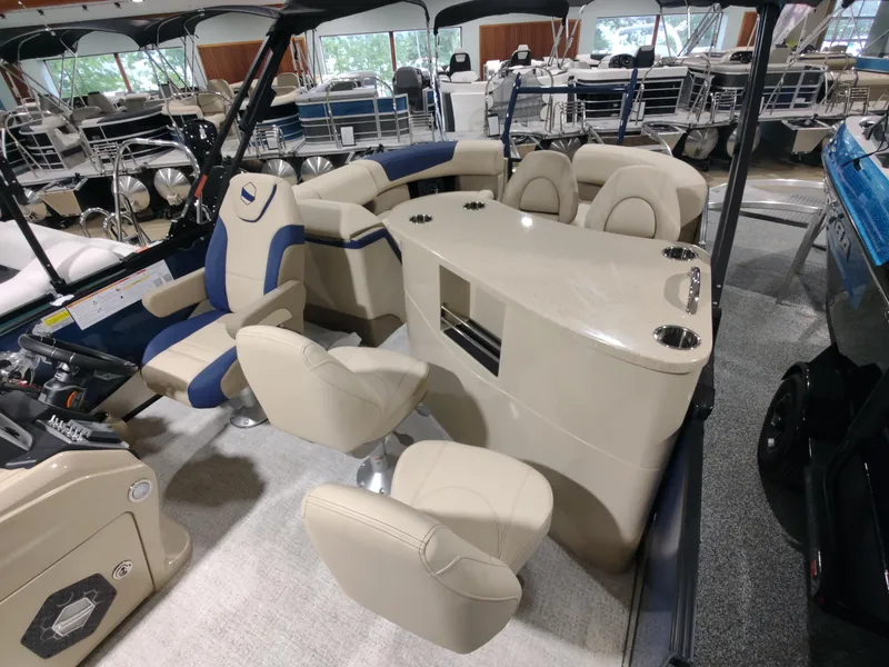 Slide: The Image of 2024 South Bay 523E 2.75 pontoon boat interior with beige and blue seating. - 7