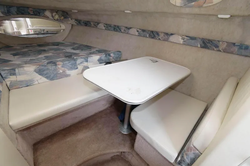 Slide: The Image of 1998 Wellcraft 260 SE cabin interior with dinette and seating area. - 10