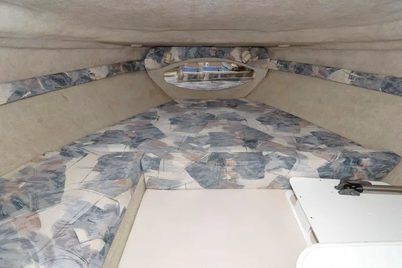 Slide: The Image of Interior cabin of a 1998 Wellcraft 260 SE boat with patterned cushions. - 12
