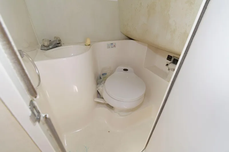 Slide: The Image of Compact bathroom in a 1998 Wellcraft 260 SE boat. - 14