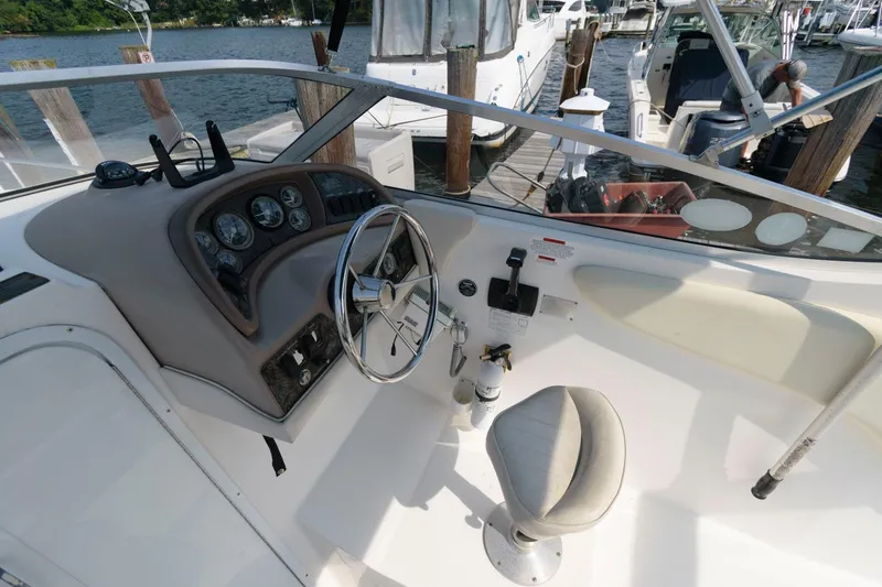 Slide: The Image of 1998 Wellcraft 260 SE boat helm with steering wheel and control panel. - 2