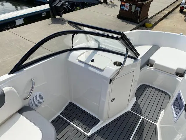 Slide: The Image of 2024 Bayliner Element E21 boat interior with seating and storage compartments. - 12