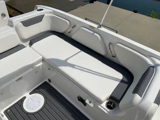 Slide: The Image of 2024 Bayliner Element E21 boat interior with white cushioned seating. - 15