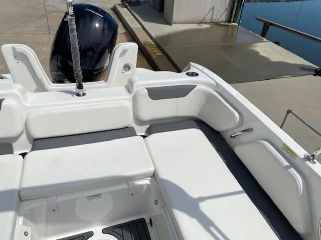 Slide: The Image of 2024 Bayliner Element E21 boat interior with white seating and outboard motor. - 16