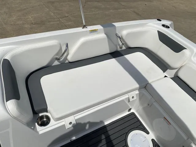 Slide: The Image of 2024 Bayliner Element E21 boat seating area with white and gray cushions. - 19