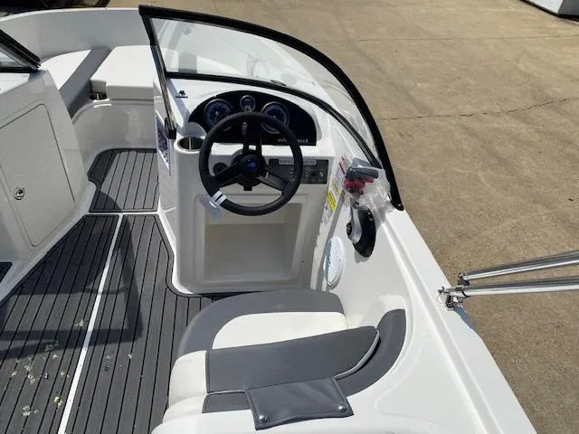 Slide: The Image of 2024 Bayliner Element E21 boat interior with steering wheel and seating. - 21