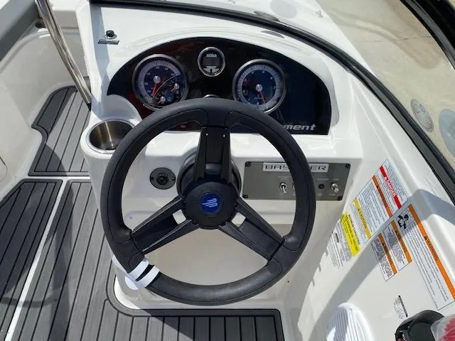 Slide: The Image of 2024 Bayliner Element E21 boat dashboard with steering wheel and instrument panel. - 22