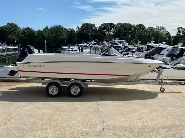 Slide: The Image of 2024 Bayliner Element E21 boat on a trailer at a marina. - 3