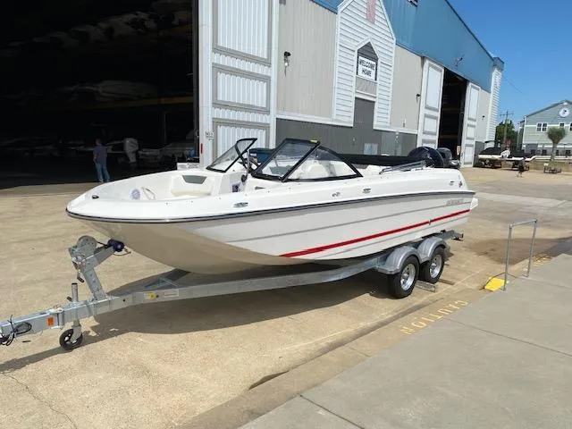 Slide: The Image of 2024 Bayliner Element E21 boat on a trailer outside a storage facility. - 6