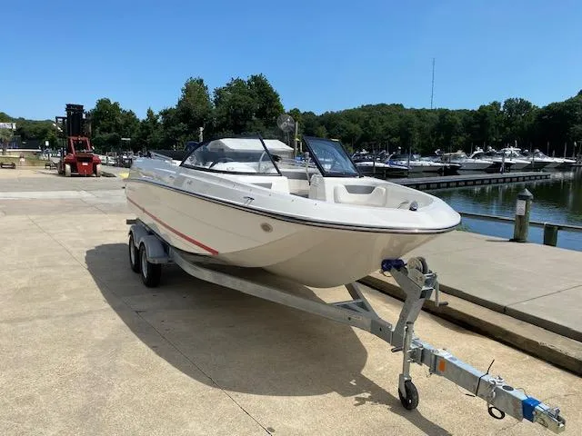 Slide: The Image of 2024 Bayliner Element E21 boat on a trailer at a marina. - 7
