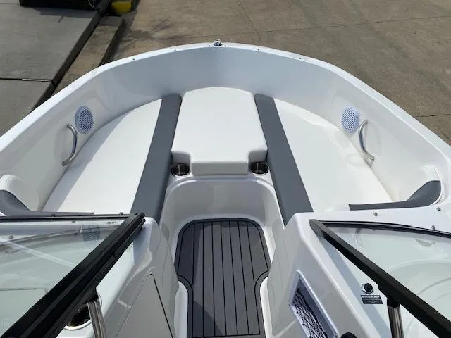 Slide: The Image of 2024 Bayliner Element E21 boat interior with cushioned seating and speakers. - 8