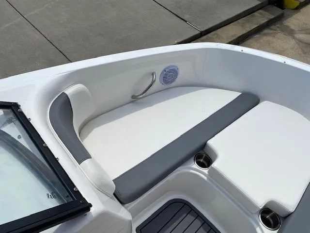 Slide: The Image of 2024 Bayliner Element E21 boat interior with cushioned seating and cup holders. - 9