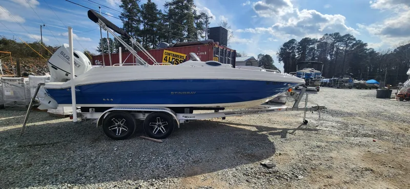 Slide: The Image of 2022 Stingray 212SC boat on a trailer in a boatyard. - 1