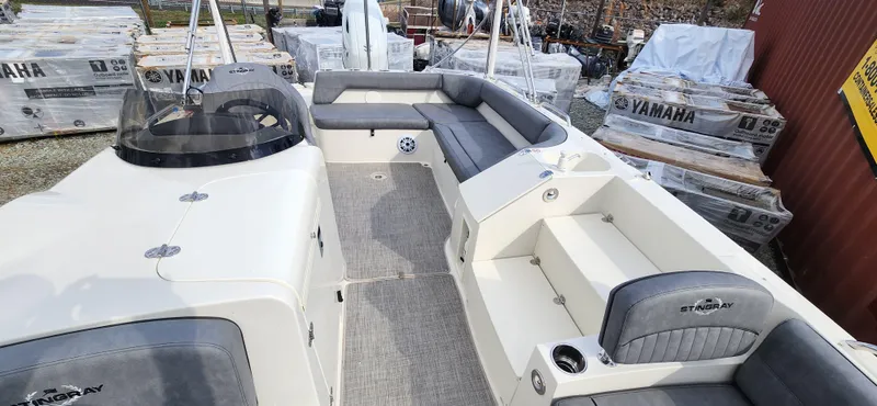 Slide: The Image of 2022 Stingray 212SC boat interior with gray seating and Yamaha outboard motors in the background. - 11