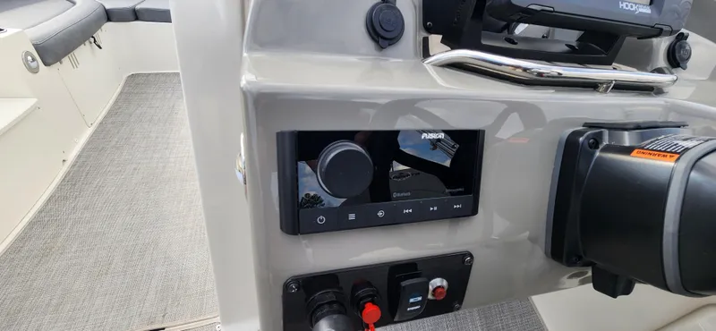 Slide: The Image of 2022 Stingray 212SC boat dashboard with Fusion stereo system and control panel. - 14