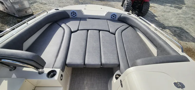 Slide: The Image of 2022 Stingray 212SC boat with spacious cushioned seating area. - 8