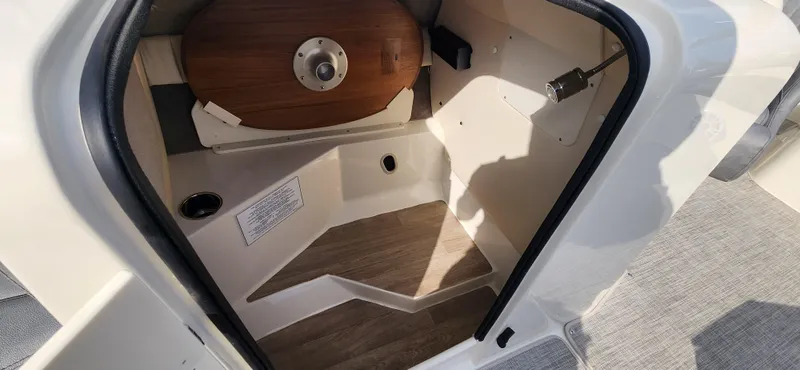 Slide: The Image of Interior cabin of 2022 Stingray 212SC boat with wooden flooring and storage space. - 9