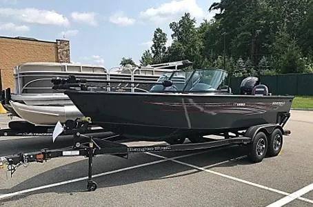 The Image of 2023 Ranger VS1882SC Angler boat on a trailer in a parking lot. - 0