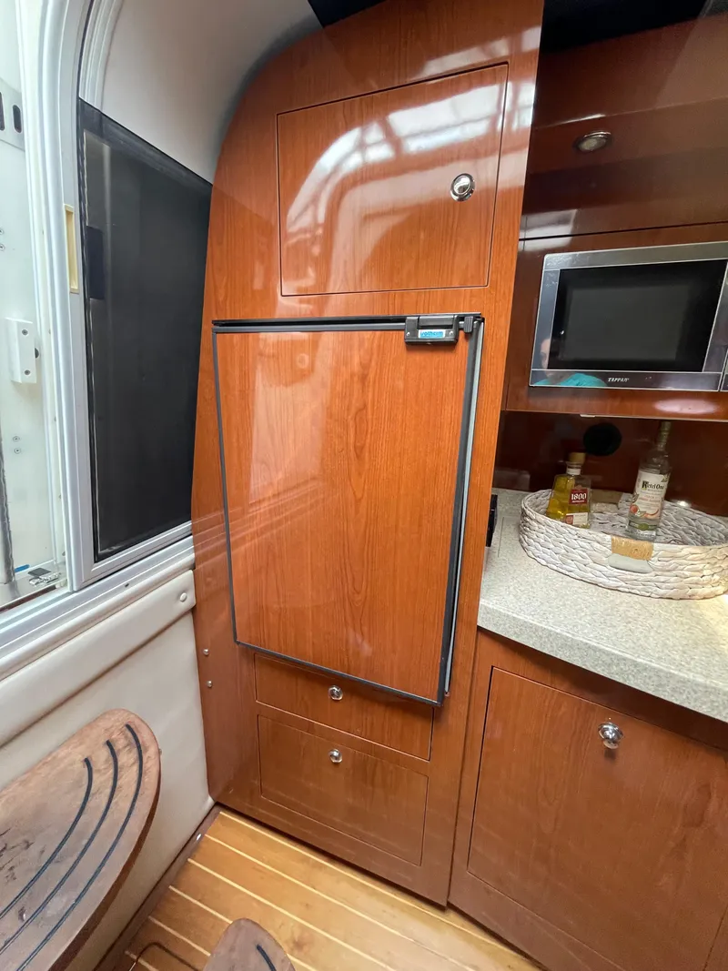 Slide: The Image of Interior of 2005 Regal Commodore 3560 IB yacht with wooden cabinetry and countertop. - 12