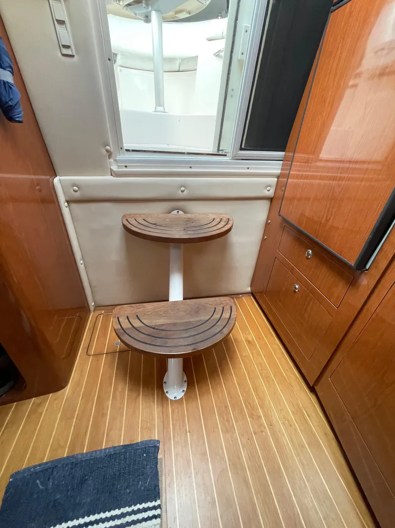 Slide: The Image of Interior steps of a 2005 Regal Commodore 3560 IB yacht with wooden flooring. - 13