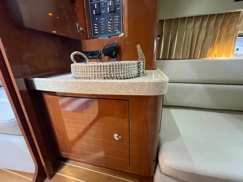 Slide: The Image of Interior of 2005 Regal Commodore 3560 IB yacht with wooden cabinetry and control panel. - 16