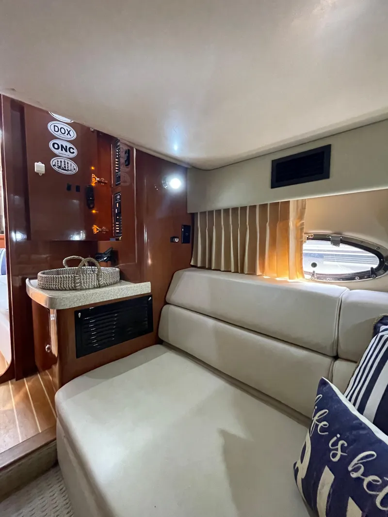Slide: The Image of Interior of 2005 Regal Commodore 3560 IB yacht with beige seating and wooden accents. - 18
