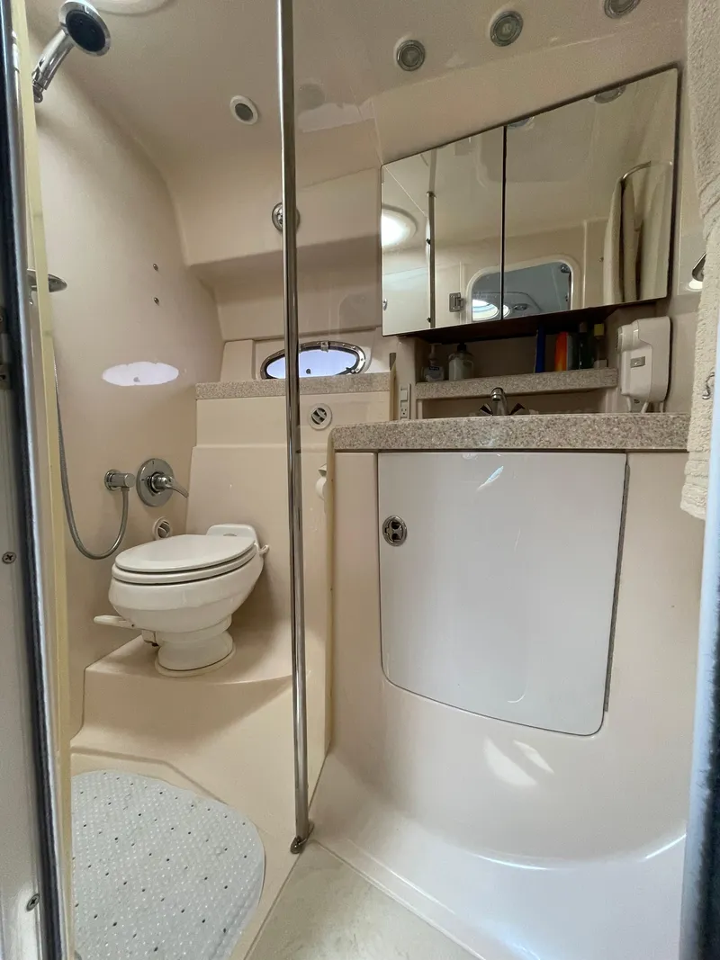 Slide: The Image of 2005 Regal Commodore 3560 IB yacht bathroom with shower, toilet, and mirrored cabinet. - 30