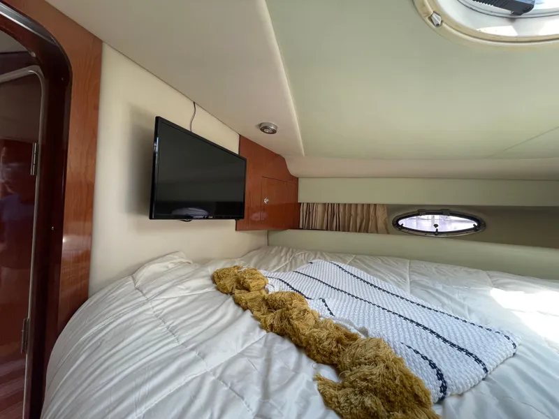 Slide: The Image of Interior cabin of 2005 Regal Commodore 3560 IB with bed, TV, and porthole window. - 32