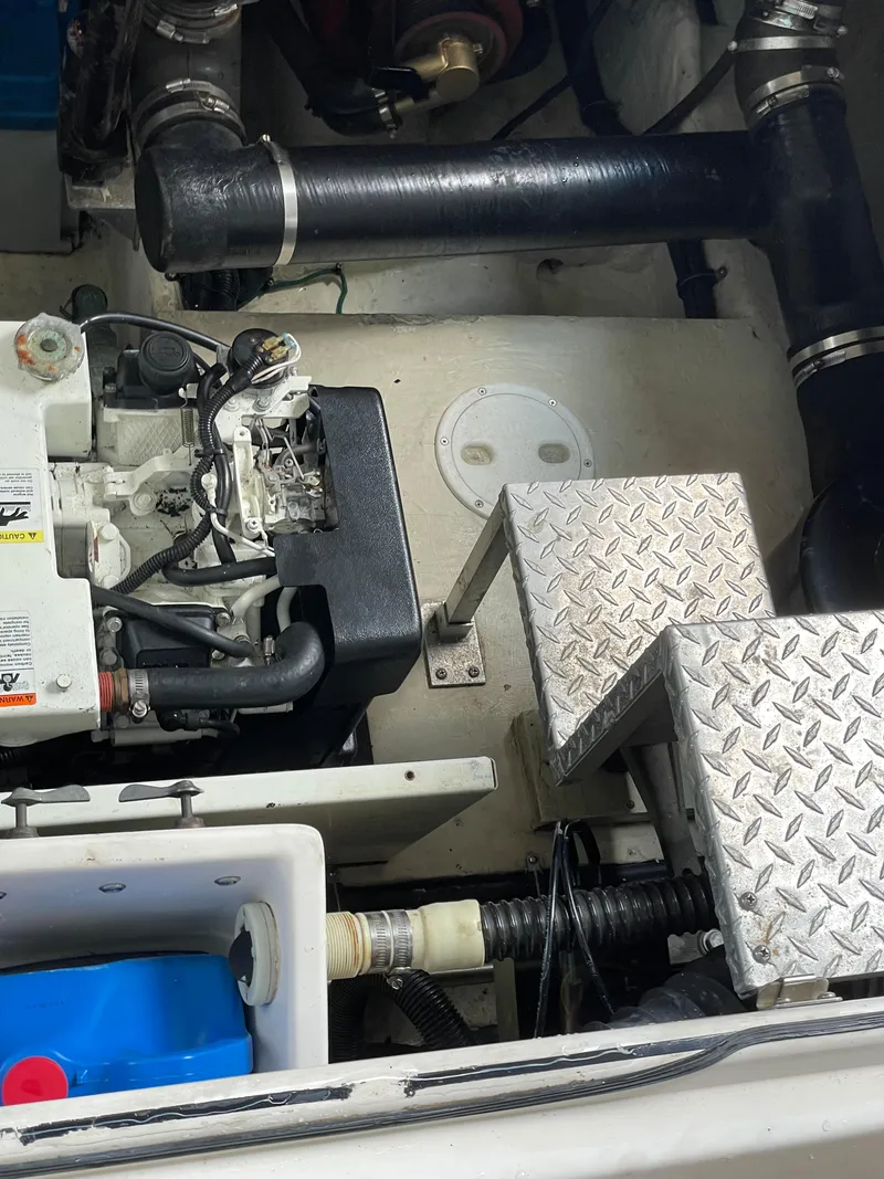 Slide: The Image of Engine compartment of a 2005 Regal Commodore 3560 IB boat with visible components and piping. - 42