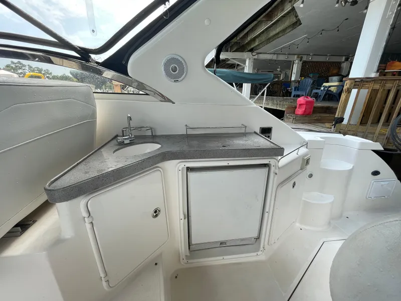 Slide: The Image of 2005 Regal Commodore 3560 IB boat interior with sink and storage. - 5
