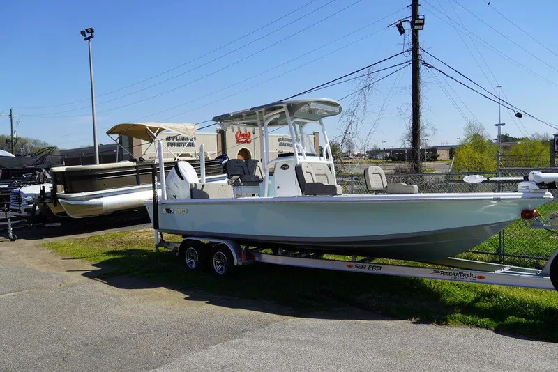 Slide: The Image of 2024 Sea Pro 248 DLX BAY boat on a trailer in a dealership lot. - 3