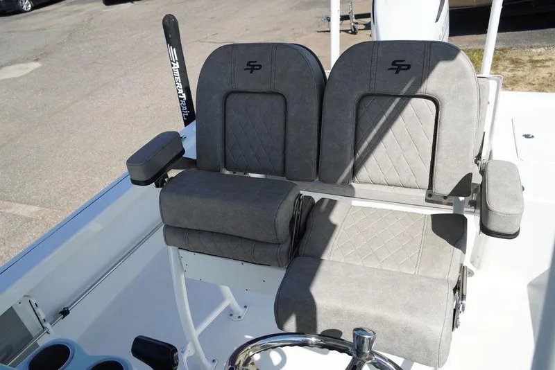 Slide: The Image of 2024 Sea Pro 248 DLX BAY boat with dual cushioned seats and steering wheel. - 5