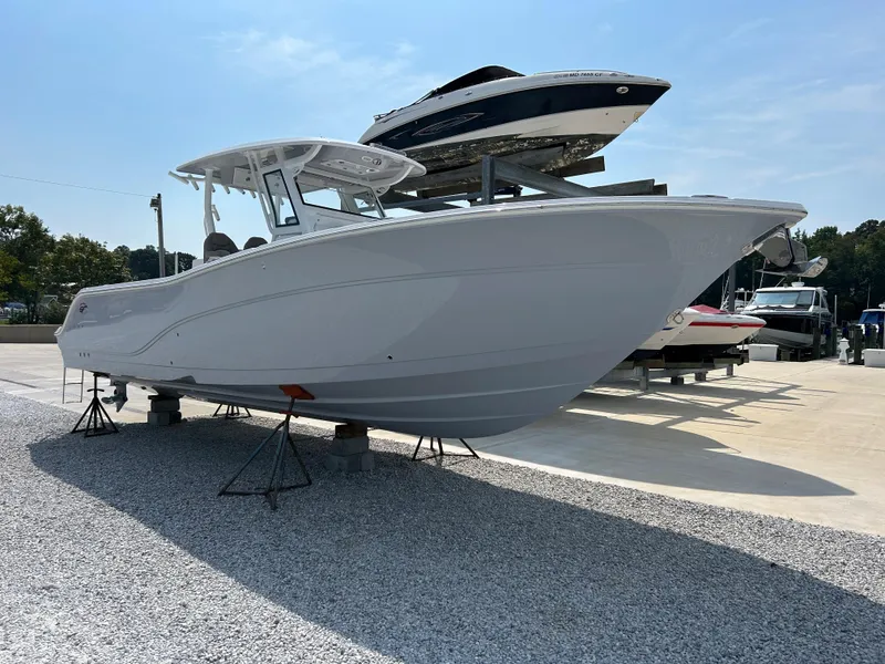 Slide: The Image of 2024 Sea Fox 328 Commander boat displayed on stands in a marina. - 3