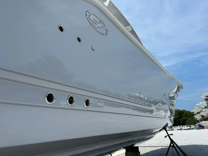 Slide: The Image of 2024 Sea Fox 328 Commander boat hull, sleek design, side view under clear blue sky. - 4