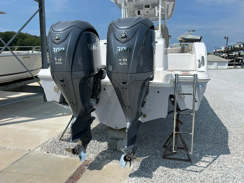 Slide: The Image of 2024 Sea Fox 328 Commander with dual Yamaha outboard engines, docked on gravel. - 5