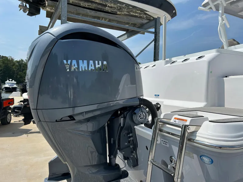 Slide: The Image of 2024 Sea Fox 328 Commander with Yamaha outboard motor, docked under clear skies. - 6