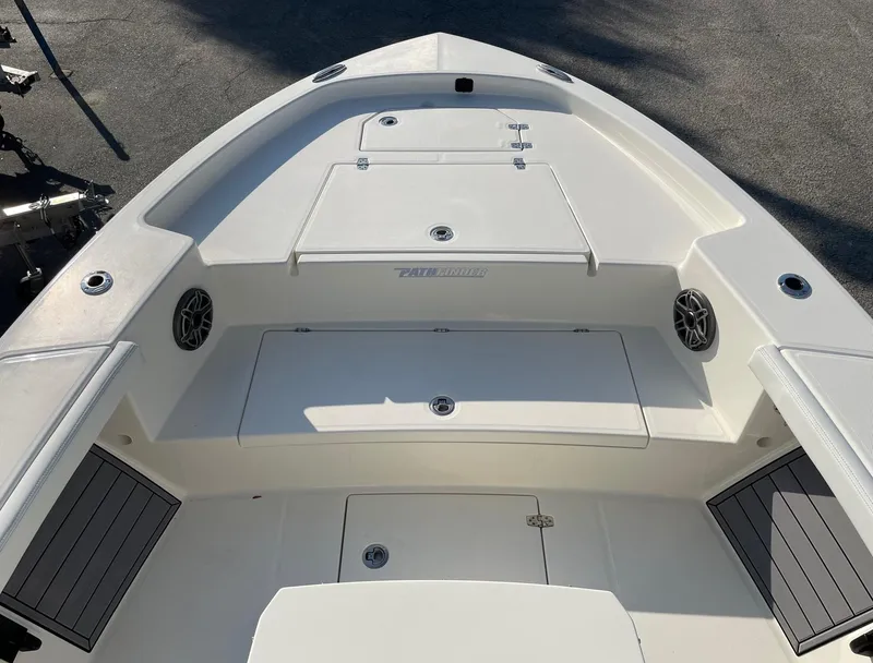 Slide: The Image of 2024 Pathfinder 2400 Open boat deck with storage compartments and speakers. - 10