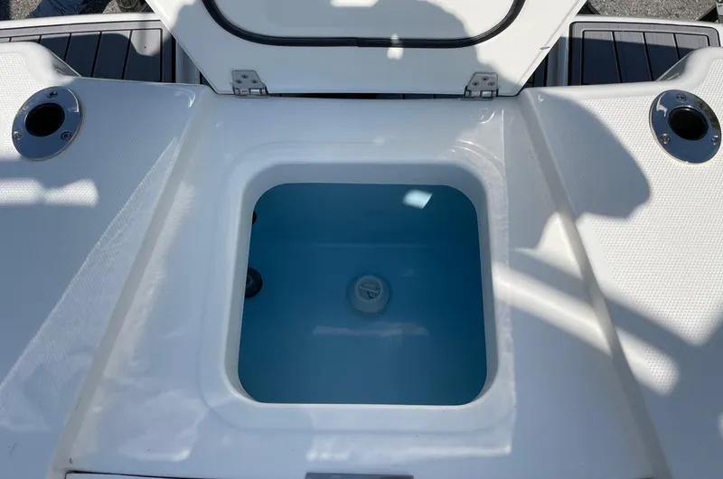 Slide: The Image of 2024 Pathfinder 2400 Open boat livewell with open lid, showcasing interior. - 12