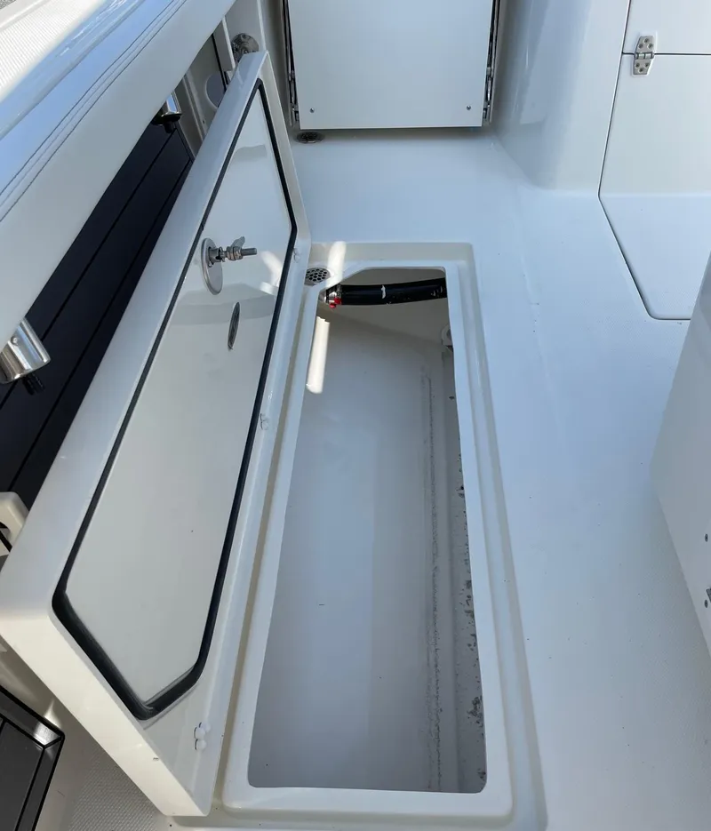 Slide: The Image of 2024 Pathfinder 2400 Open boat storage compartment with open hatch. - 13