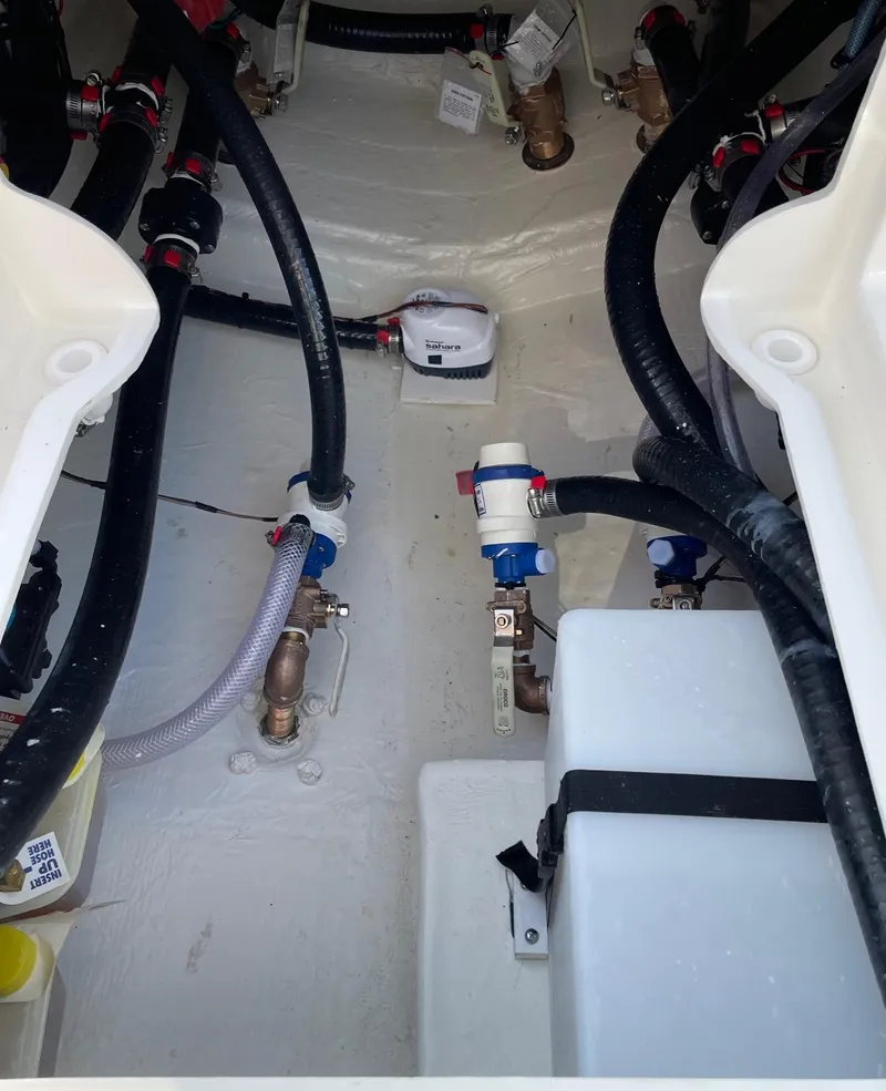 Slide: The Image of 2024 Pathfinder 2400 Open boat interior with visible plumbing and wiring. - 16