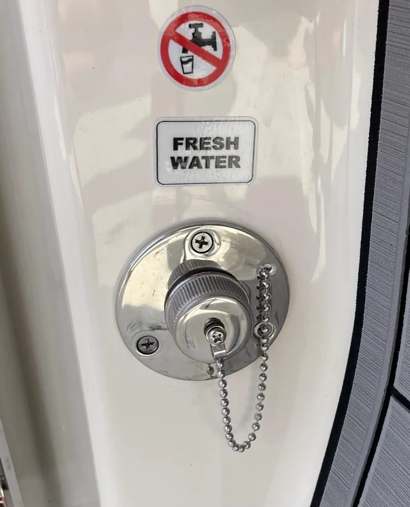 Slide: The Image of 2024 Pathfinder 2400 Open fresh water fill port with no fuel symbol. - 18