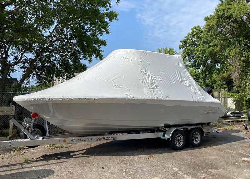 Slide: The Image of 2024 Pathfinder 2400 Open boat covered on trailer, parked outdoors. - 19